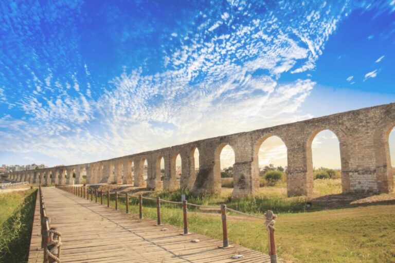 Ancient aqueduct in Larnaca under a blue sky